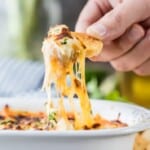 Queso Fundido is the dreamy Crock Pot Queso Recipe of your dreams! Slow Cooker Queso Fundido with Chorizo couldn't be easier, creamier, or more delicious! If you're celebrating something...from Cinco de Mayo to the Super Bowl, this Easy Cheese Dip with Sausage is the perfect recipe.