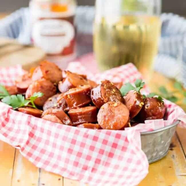 Crock Pot Kielbasa Sausage Bites are a tailgating favorite! This sweet and spicy kielbasa appetizer is SO EASY to make. There's nothing better than a slow cooker kielbasa recipe to make an easy game day appetizer. They are so addicting!