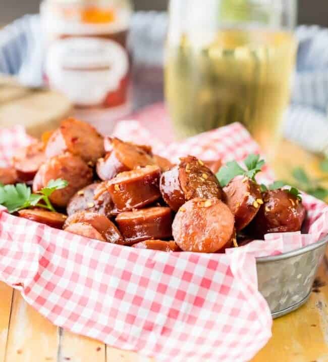 Crock Pot Kielbasa Sausage Bites are a tailgating favorite! This sweet and spicy kielbasa appetizer is SO EASY to make. There's nothing better than a slow cooker kielbasa recipe to make an easy game day appetizer. They are so addicting!