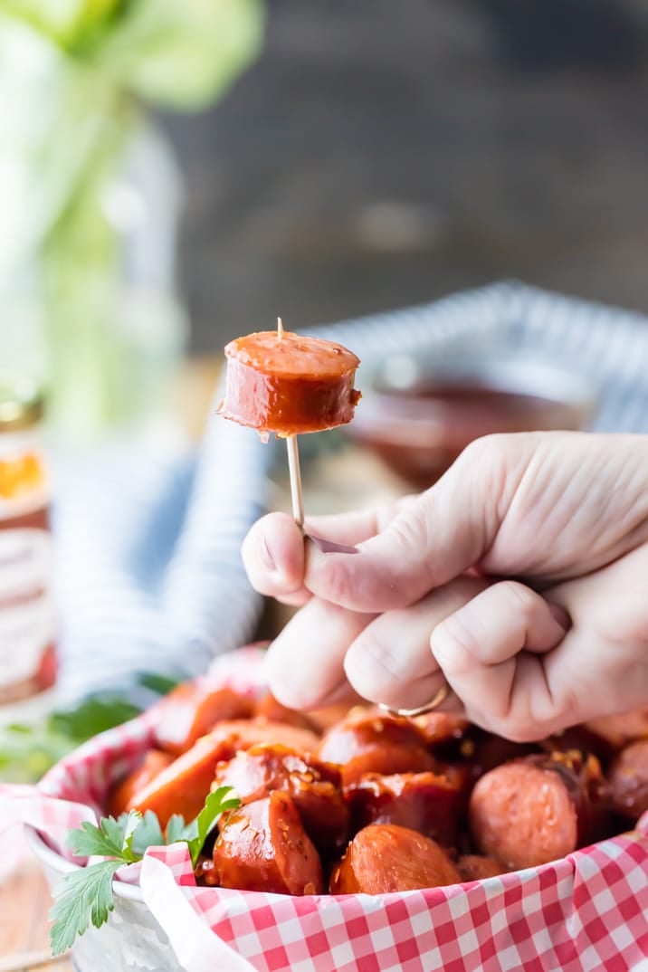 Slow Cooker Sweet and Spicy Kielbasa is our FAVORITE easy party appetizer! Made with pepper jelly and bbq sauce, SO GOOD!