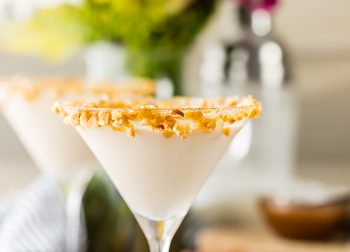 close up view of martini with crushed peanuts on the rim