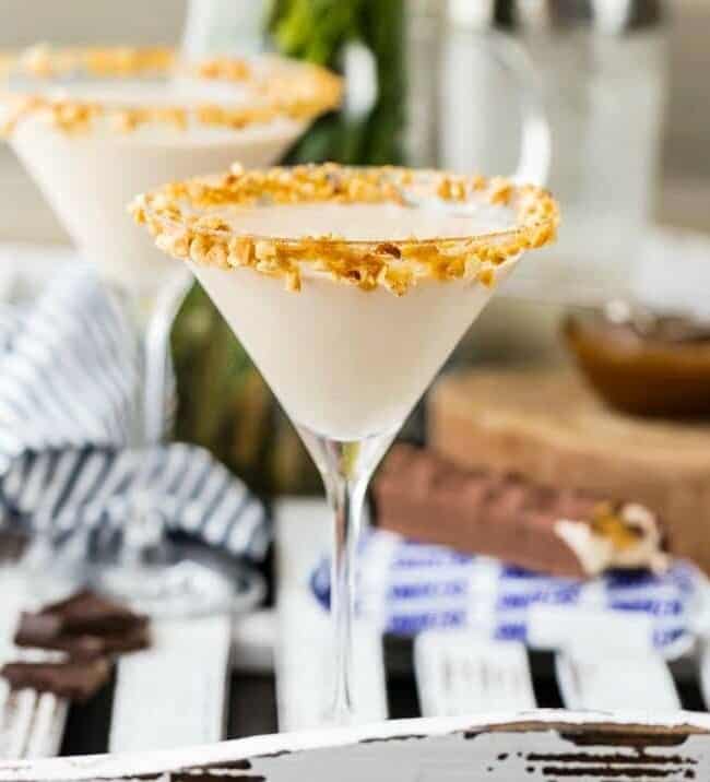 two martini glasses rimmed with crushed nuts