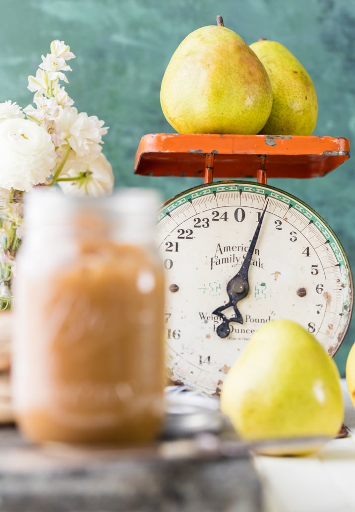 pear butter next to a scale weighing pears