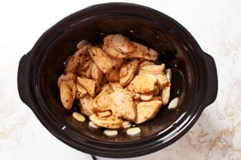 cooked chicken and cashews in a crockpot.