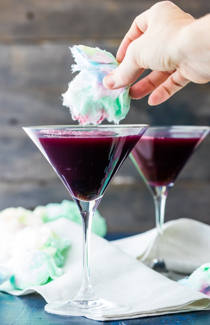 hand putting cotton candy in glass