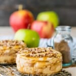 FALL BAKING IS HERE! Start the season with these simple and divine Mini Apple Pie Cheesecakes! You can't mess these up! Apple Pie sandwiched between two layers of perfect cheesecake!