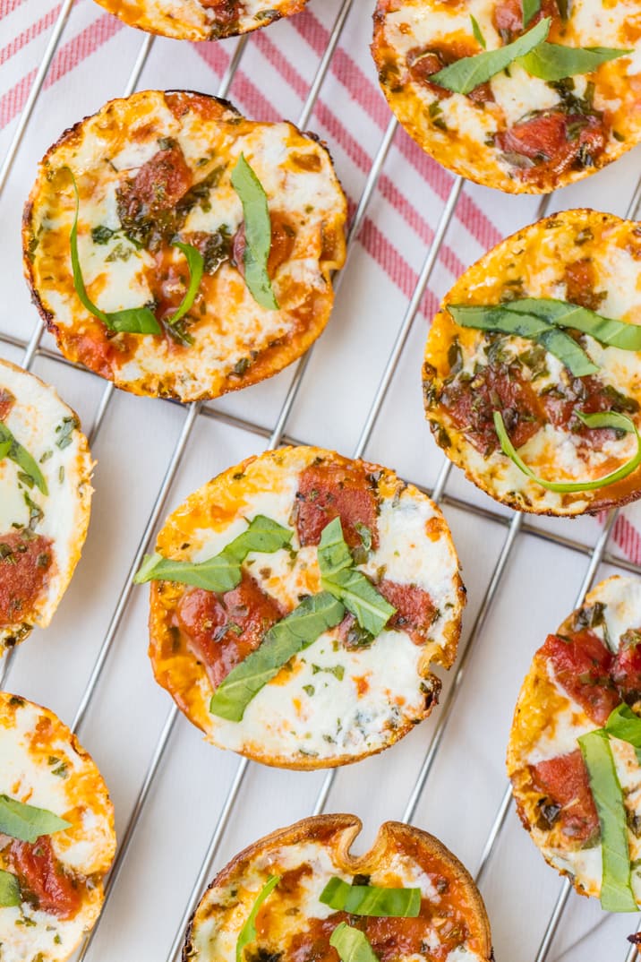 small margherita pizzas on a baking rack