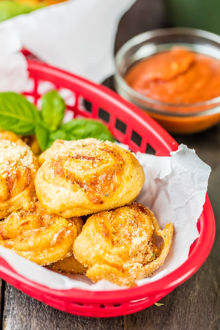 Stuffed Pepperoni Pizza Rolls in a basket next to a dipping sauce