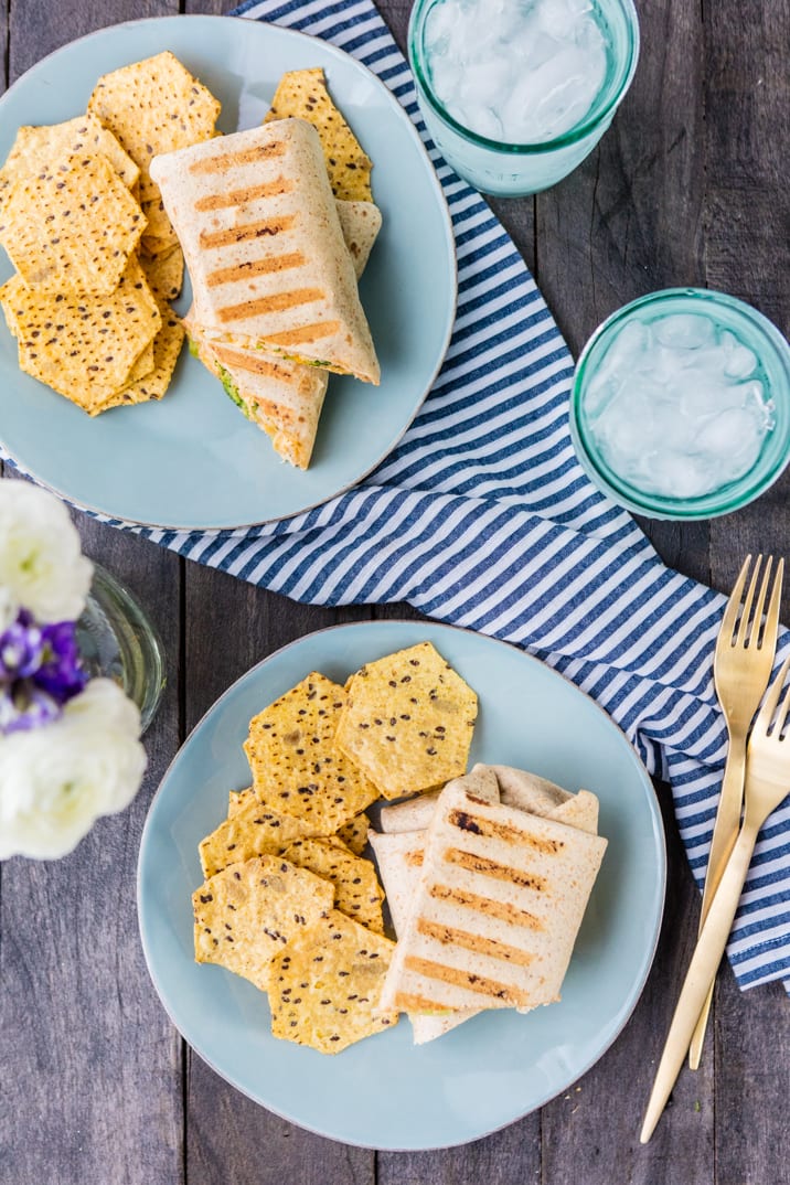 tablescape with plates of wraps and chips