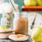 a mason jar full of easy bear butter behind english muffins