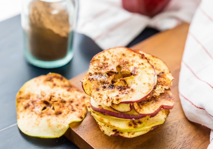 stack of cinnamon sugar microwave apple chips with cinnamon in background