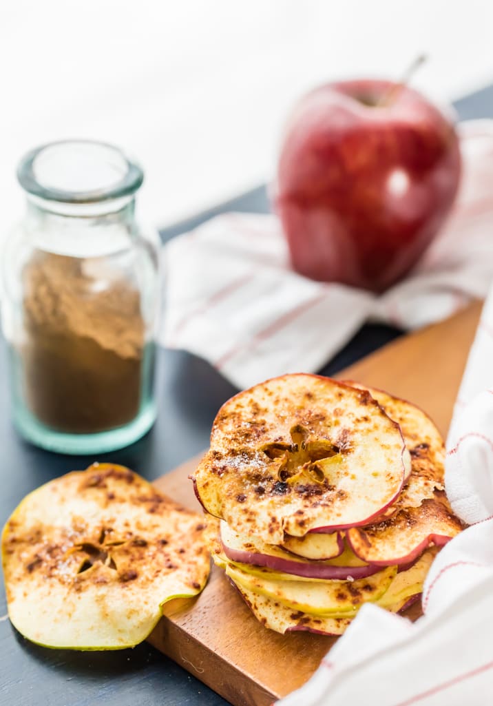 cinnamon sugar microwave apple chips with cinnamon and apple in background