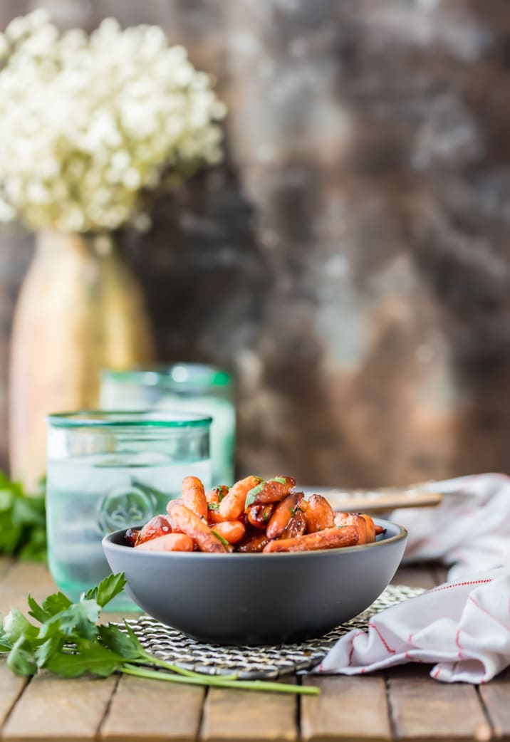 Honey Balsamic Roasted Carrots on a table with glasses of iced water