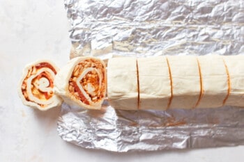 sliced pepperoni pizza roll log with 2 pinwheels facing up.