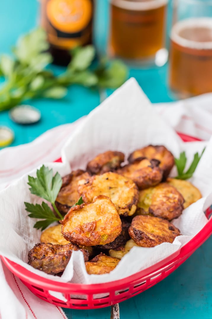 Ranch Fried Pickles are the perfect easy snack or sandwich topper! Crispy and crunchy, with a tangy ranch flavor. So addicting! A plate of food on a table, with Pickle and Fried pickle