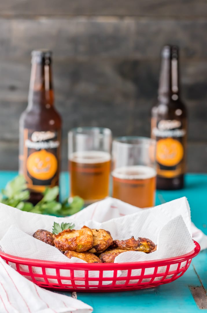 Ranch Fried Pickles are the perfect easy snack or sandwich topper! Crispy and crunchy, with a tangy ranch flavor. So addicting! A plate of food and a bottle on a table, with Pickle and Fried pickle