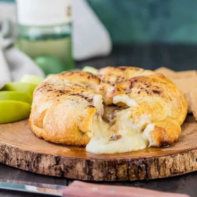 Apple Pie Baked Brie...a beautiful and delicious appetizer fit for any holiday party! We make this every Thanksgiving and Christmas and it's a party favorite every time!