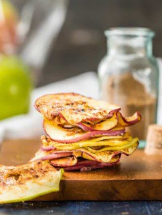 A stack of apple slices on a cutting board.