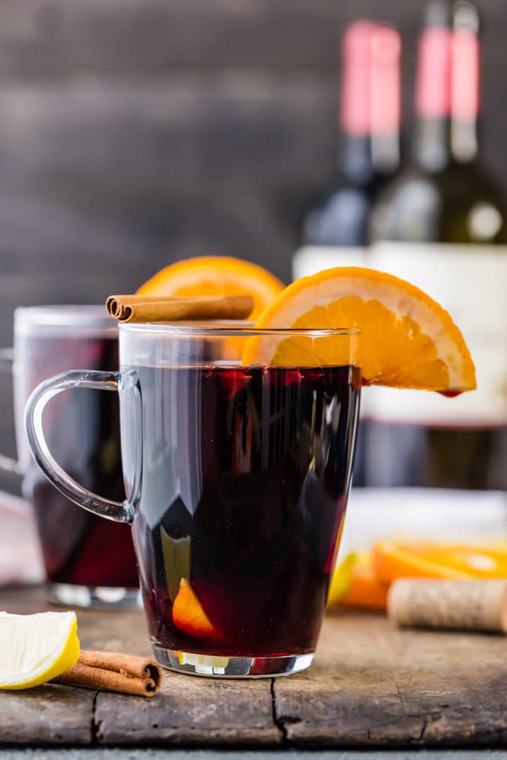 Glass of spiced wine with an orange slice and cinnamon stick sitting on top