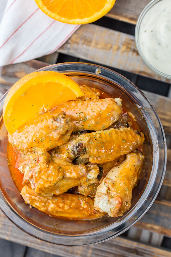 baked hot wings in a bowl with hot wing sauce