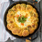 a skillet filled with an egg and cheese dish.