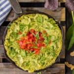 guacamole dip in a skillet on a wooden table.