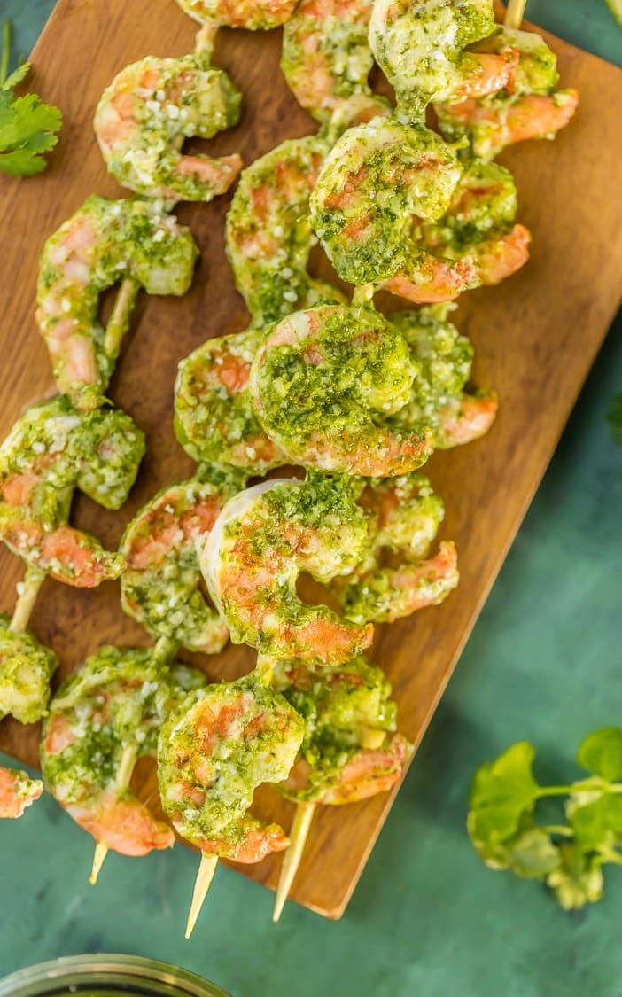 stacks of Pesto Shrimp skewers on a wooden board