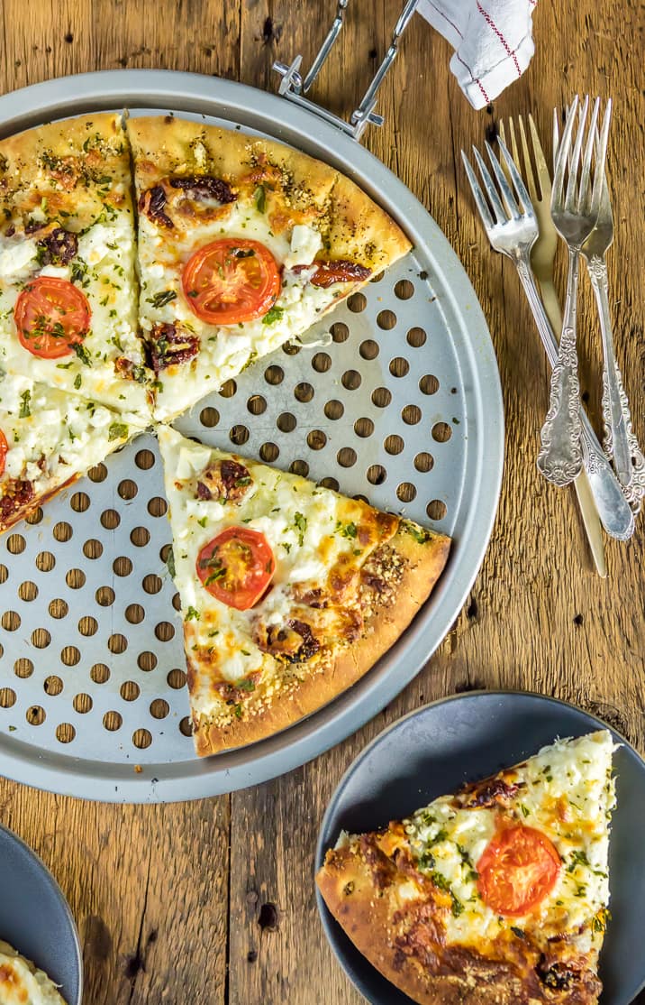 easy gourmet white pizza on pizza tray and on a plate with forks