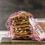 a stack of flourless hot chocolate cookies tied up with red and white stripped string