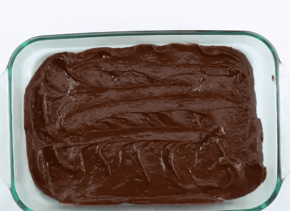 Brownie batter in glass baking dish. 