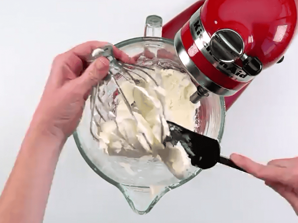 Creaming cream cheese in a stand mixer. 