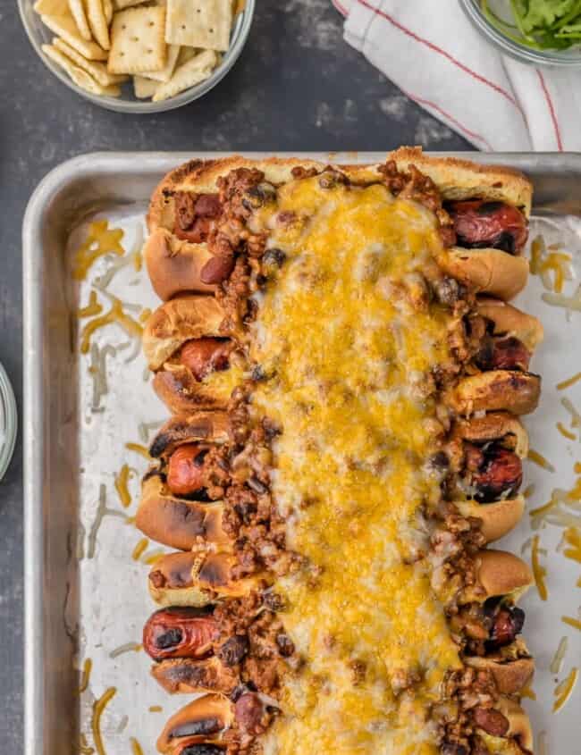 This Chili Dog Recipe all baked together on a sheet pan is the BEST Chili Dog Recipe ever! These Chili Cheese Dogs topped with the best hot dog chili recipe. If you're in the mood for comfort food; toasted buns, grilled hot dogs, best ever chili, and of course tons of cheese; this recipe is for you! 
