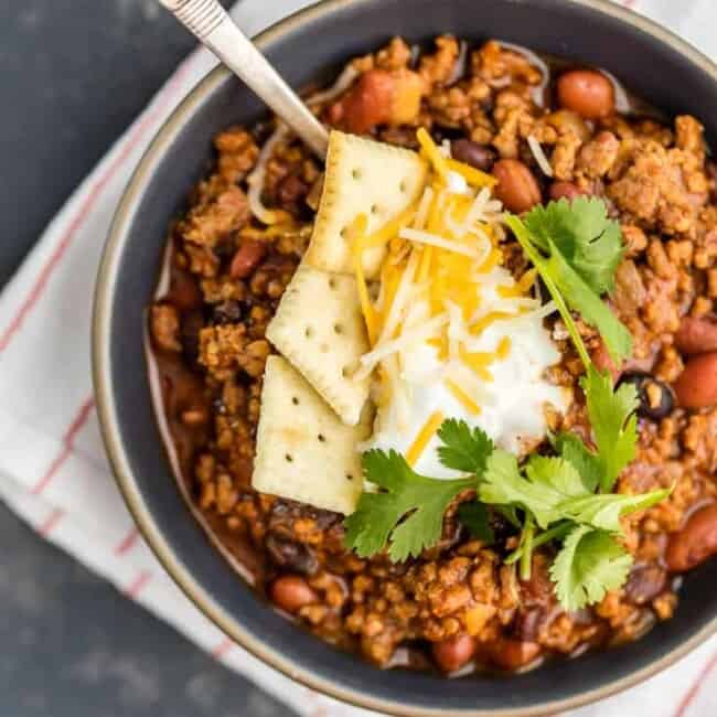 This Best Chili Recipe has been in our family for years. I've had a lot of chili in my life, from white chicken chili to vegetarian chili, and this is hand's down the BEST CHILI I have ever tasted. Two types of meat, lots of beans, and loaded with cheese, sour cream, crackers, and more! You will want to eat this Best Easy Chili Recipe year round, not just the cold months. 
