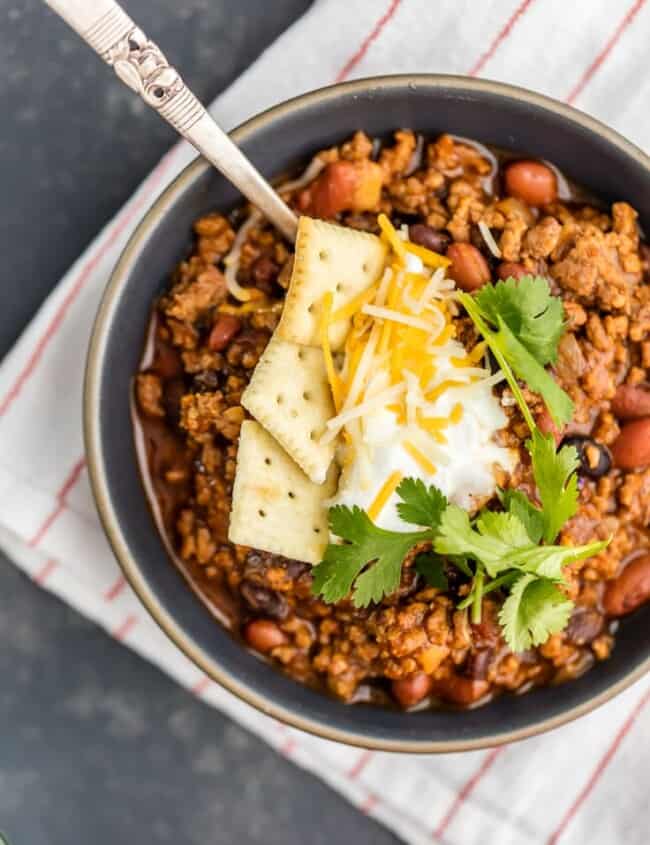 This Best Chili Recipe has been in our family for years. I've had a lot of chili in my life, from white chicken chili to vegetarian chili, and this is hand's down the BEST CHILI I have ever tasted. Two types of meat, lots of beans, and loaded with cheese, sour cream, crackers, and more! You will want to eat this Best Easy Chili Recipe year round, not just the cold months. 