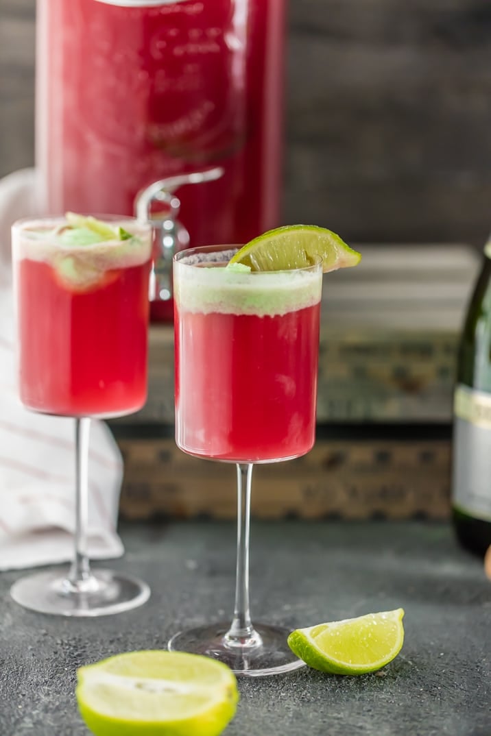 Two glasses of cranberry limeade holiday champagne punch