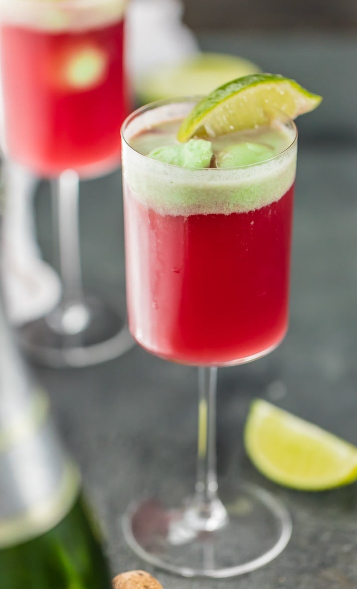 one glass of cranberry limeade holiday champagne punch