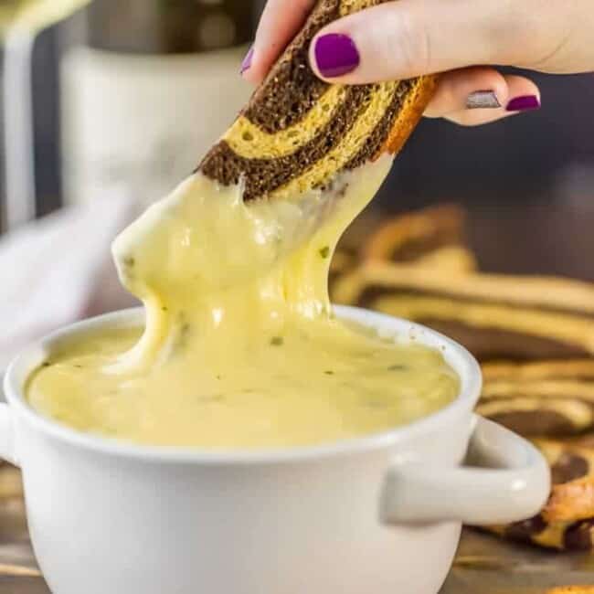 crostini being dipped in fondue
