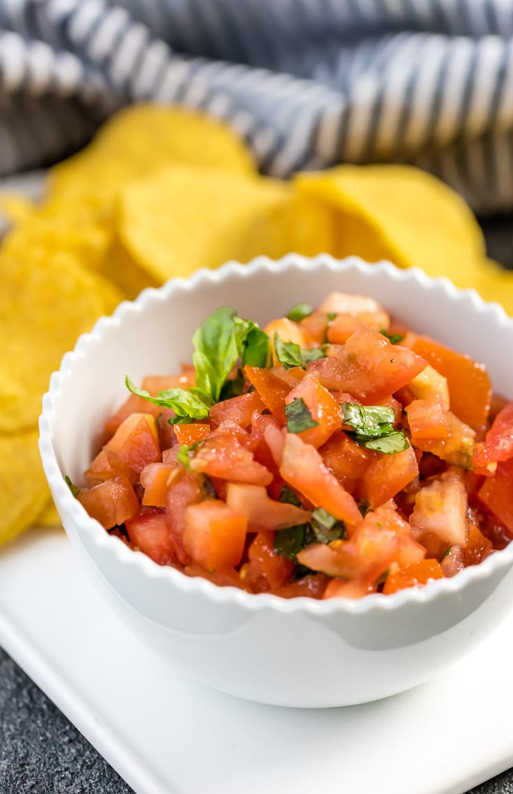 Italian salsa in white bowl with tortilla chips.