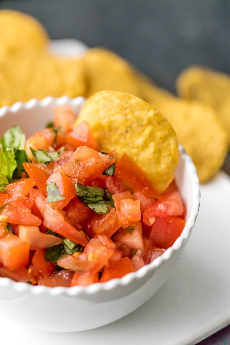 Italian salsa with chip dipped into it.