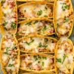SUPER EASY Oven Baked Spicy Chicken Tacos make a weekly appearance on our table. All the flavor and none of the stress. ALL THAT MELTED CHEESE! Perfect Chicken Tacos recipe for a crowd on Family Mexican Night!