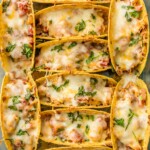 SUPER EASY Oven Baked Spicy Chicken Tacos make a weekly appearance on our table. All the flavor and none of the stress. ALL THAT MELTED CHEESE! Perfect Chicken Tacos recipe for a crowd on Family Mexican Night!