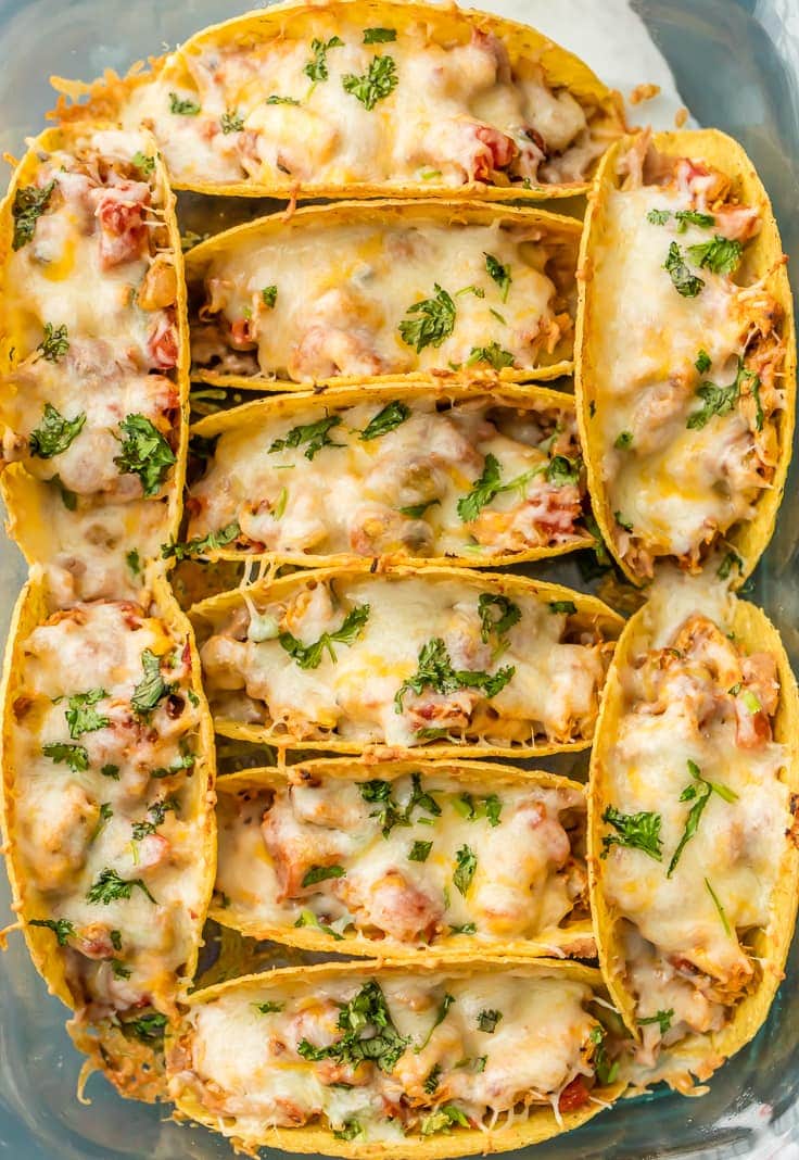 overhead view of baked chicken tacos arranged in a baking dish