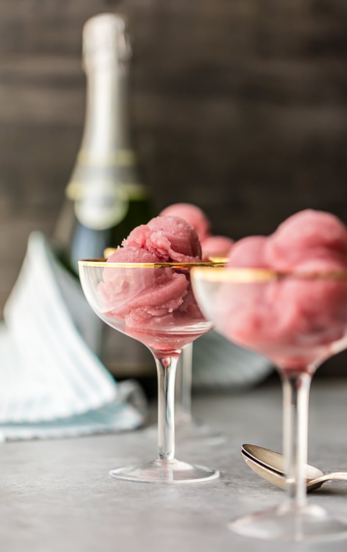 3 glasses of champagne sorbet with a bottle of champagne in the background