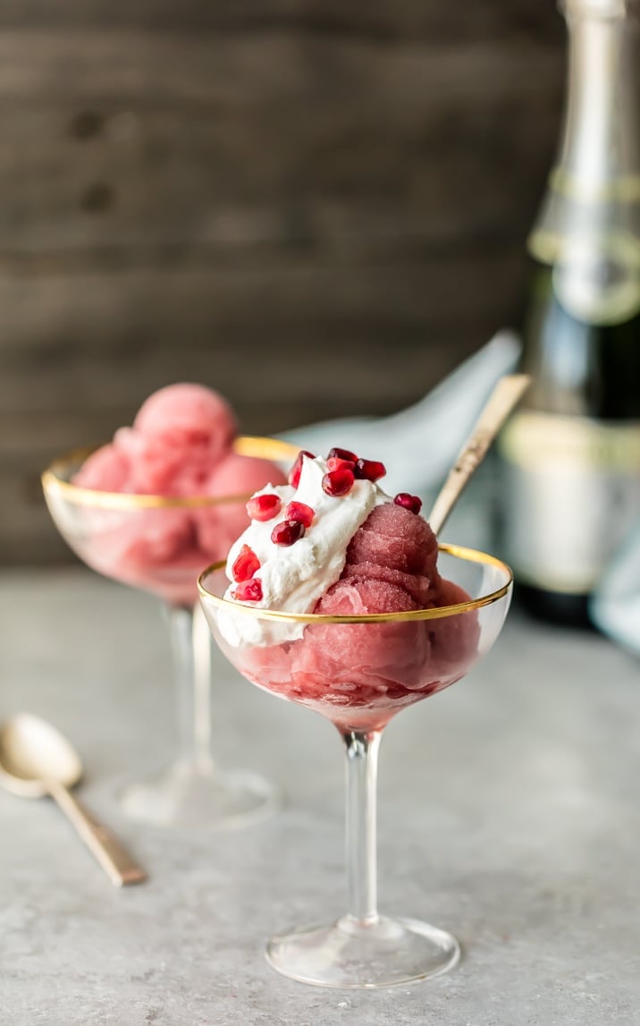 Pomegranate sorbet topped with whipped cream and pom arils