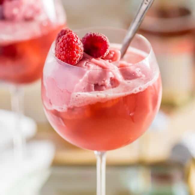 Raspberry Pink Champagne Floats, made with pink champagne and raspberry sorbet are the perfect Valentine's treat! Sorbet Mimosas are perfect for New Years Eve, Valentine's Day, baby showers, or wedding showers! Beautiful, EASY, and delicious!
