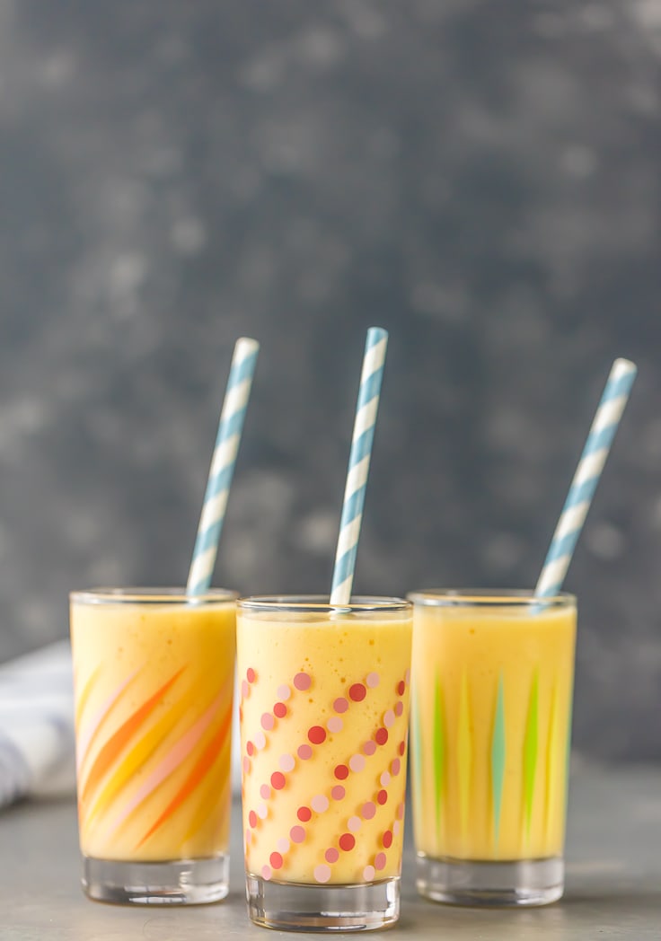 three simple mango smoothies with straws