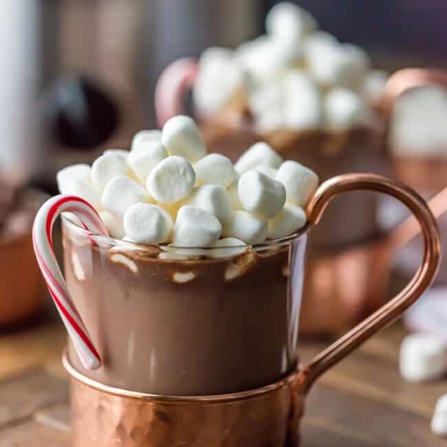 We LOVE Slow Cooker Peppermint Hot Chocolate! Made with sweetened condensed milk so its SUPER CREAMY crockpot hot chocolate. The perfect Winter drink for Christmas!