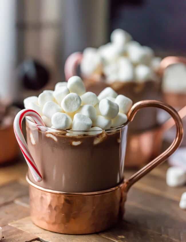 We LOVE Slow Cooker Peppermint Hot Chocolate! Made with sweetened condensed milk so its SUPER CREAMY crockpot hot chocolate. The perfect Winter drink for Christmas!