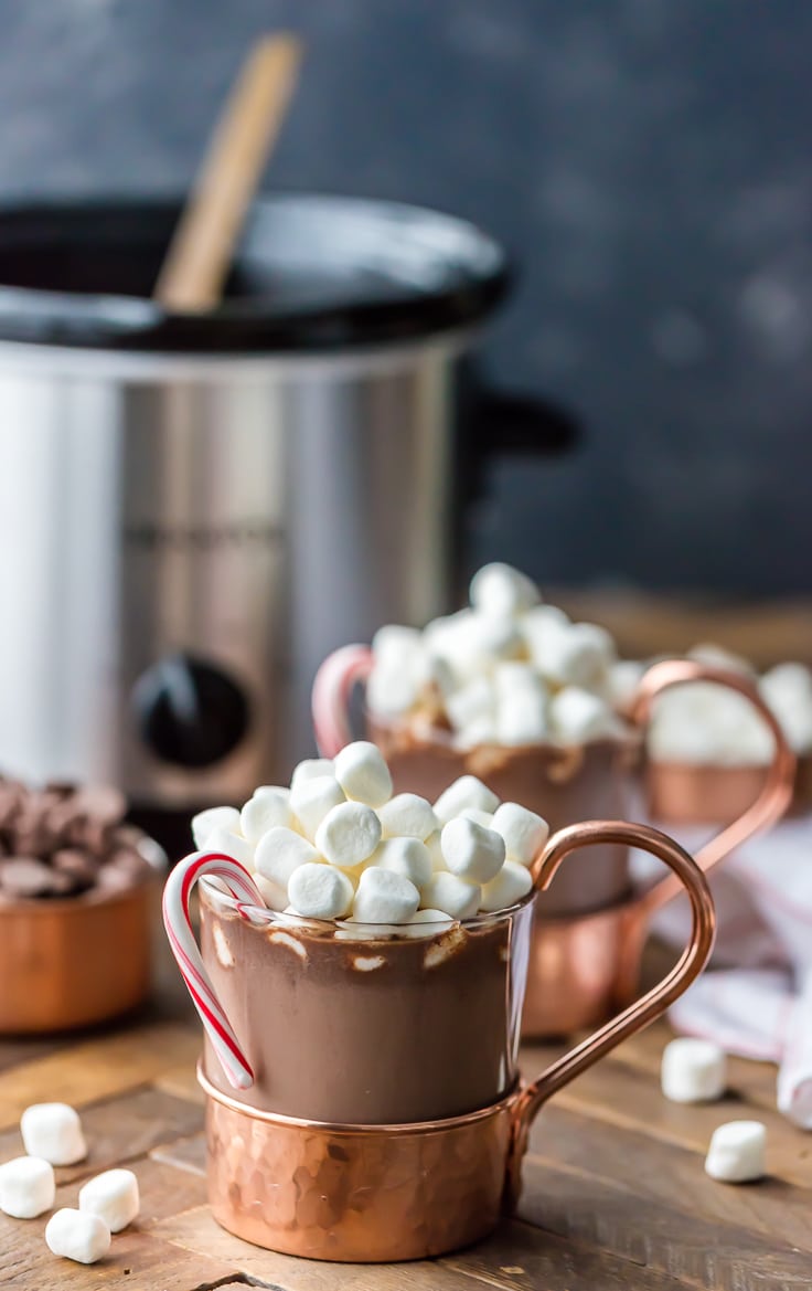 Peppermint Hot Chocolate in a glass and bronze mug, topped with marshmallows