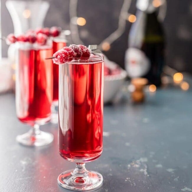 Sugared Cranberry Ginger Mimosas, ONLY THREE INGREDIENTS! Easy holiday cocktail recipe perfect for Thanksgiving, Christmas, and Valentine's Day! Pretty Red Cocktail!